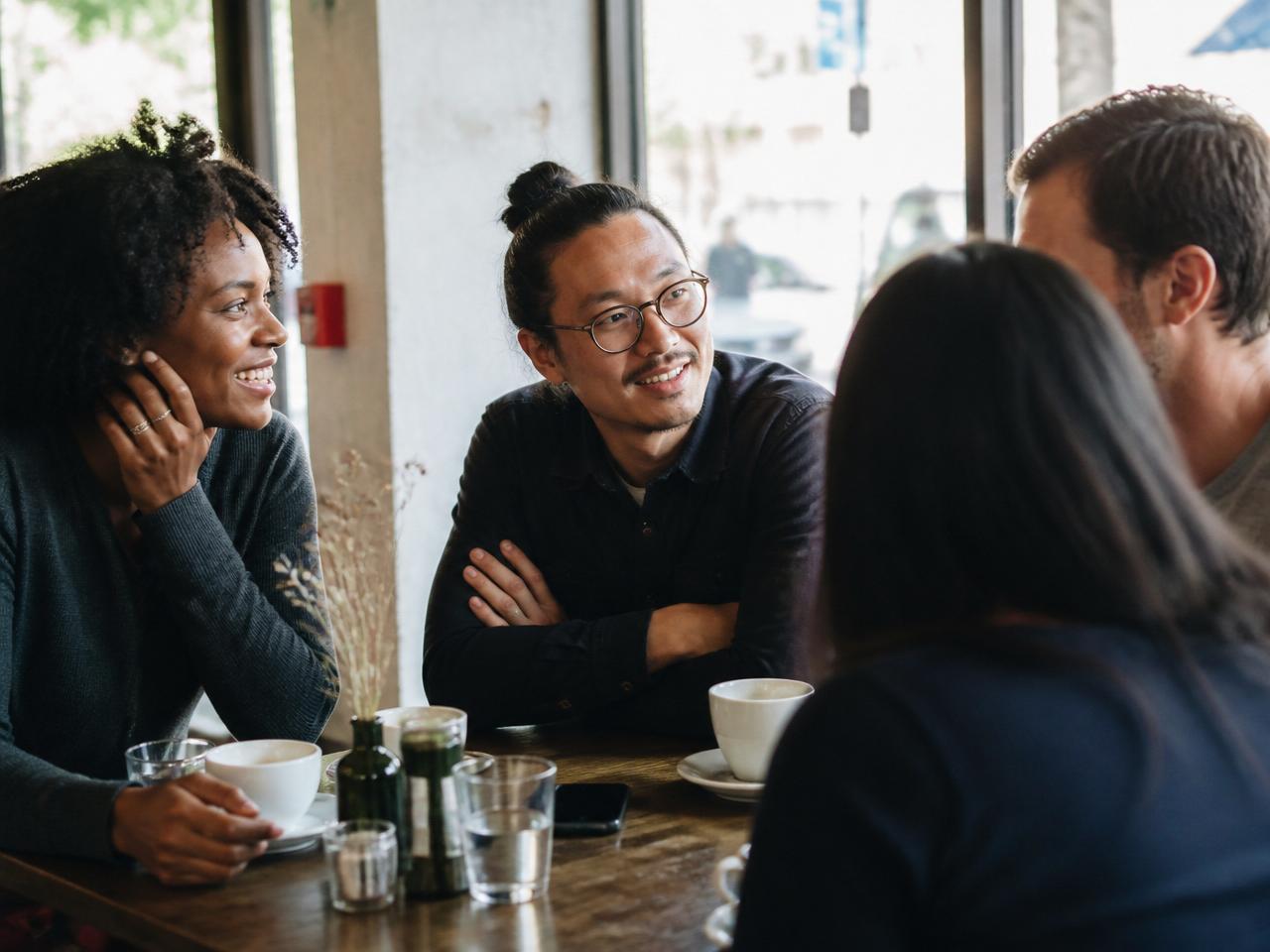 Friends sharing a candid conversation over coffee